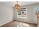 Bright dining area features hardwood floors, a window overlooking the backyard, and modern lighting at 2121 Ramsgate St, Raleigh, NC 27603