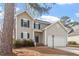 Inviting two-story home featuring a blue front door, gray siding, and a spacious two-car garage at 2121 Ramsgate St, Raleigh, NC 27603