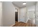 Neutral hallway with a view to an adjacent room, and white paneled doors at 2121 Ramsgate St, Raleigh, NC 27603
