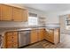Well-lit kitchen with wood cabinets, granite countertops, stainless steel appliances, and modern fixtures at 2121 Ramsgate St, Raleigh, NC 27603