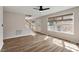 Bright living room featuring hardwood floors, large windows, and a staircase leading to the upper level at 2121 Ramsgate St, Raleigh, NC 27603
