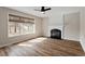Inviting living room with a fireplace, hardwood floors, a ceiling fan, and a view of the backyard at 2121 Ramsgate St, Raleigh, NC 27603