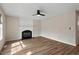 Cozy living room with hardwood floors, a fireplace, a ceiling fan, and neutral paint colors at 2121 Ramsgate St, Raleigh, NC 27603