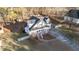 Aerial view showcasing a charming two-story home with a welcoming front porch and a spacious driveway at 214 Linville Ln, Willow Springs, NC 27592