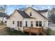 Rear exterior view of the house showing the deck, white siding, and well-maintained yard at 214 Linville Ln, Willow Springs, NC 27592