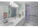 Bathroom with double sinks, large mirror, and a shower with glass door for a modern touch at 214 Linville Ln, Willow Springs, NC 27592