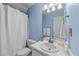 Simple bathroom featuring a single sink vanity, a toilet, and a shower with a curtain at 214 Linville Ln, Willow Springs, NC 27592