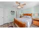 Calm and airy bedroom featuring a comfortable bed, ceiling fan, and natural light at 214 Linville Ln, Willow Springs, NC 27592