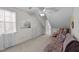 Bonus room featuring a futon, a ceiling fan, and attic storage for a multitude of purposes at 214 Linville Ln, Willow Springs, NC 27592