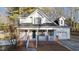 Charming two-story home with a brick foundation, covered porch, and a well-manicured front yard at 214 Linville Ln, Willow Springs, NC 27592