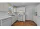 Clean, all-white kitchen with an oven, sink, lots of cabinet space, and natural light at 214 Linville Ln, Willow Springs, NC 27592