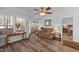 Inviting living room with hardwood floors, a ceiling fan, and views of the backyard at 214 Linville Ln, Willow Springs, NC 27592