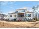 Charming white home featuring a screened-in porch, outdoor patio, and a pristine backyard at 2412 Toll Mill Ct, Raleigh, NC 27606
