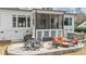 Well-appointed backyard patio with a grill, comfortable seating, and a view of the screened porch above at 2412 Toll Mill Ct, Raleigh, NC 27606