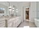 Bright bathroom featuring double sinks, marble countertop, and a view to walk-in closet at 2412 Toll Mill Ct, Raleigh, NC 27606