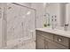 Modern bathroom featuring a marble shower, vanity with sink and a mirror at 2412 Toll Mill Ct, Raleigh, NC 27606