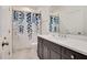 Bathroom with a shower tub combo featuring a lovely blue floral curtain and dark vanity at 2412 Toll Mill Ct, Raleigh, NC 27606