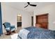 Cozy bedroom features a ceiling fan and an adjacent bathroom with a dark vanity at 2412 Toll Mill Ct, Raleigh, NC 27606