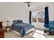 Bright bedroom with a ceiling fan, cozy rocking chair and natural light from the window at 2412 Toll Mill Ct, Raleigh, NC 27606