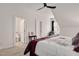 Cozy bedroom featuring a ceiling fan, a small window, and a bathroom entrance at 2412 Toll Mill Ct, Raleigh, NC 27606