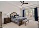 Bright bedroom featuring a large window, decorative bedding and bedside tables at 2412 Toll Mill Ct, Raleigh, NC 27606