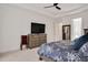 Well decorated bedroom with ceiling fan, TV and furniture at 2412 Toll Mill Ct, Raleigh, NC 27606