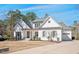 Inviting white brick home featuring a manicured lawn and mature trees at 2412 Toll Mill Ct, Raleigh, NC 27606