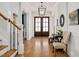 An elegant foyer enhanced by a beautiful chandelier and staircase at 2412 Toll Mill Ct, Raleigh, NC 27606