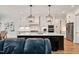Modern kitchen with a large island, stainless appliances, pendant lighting, and white cabinetry at 2412 Toll Mill Ct, Raleigh, NC 27606