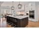 Gourmet kitchen with a large island, stainless steel appliances, and an open concept to the living area at 2412 Toll Mill Ct, Raleigh, NC 27606
