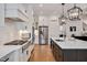 Kitchen featuring white cabinetry, a stainless steel refrigerator, and a large center island at 2412 Toll Mill Ct, Raleigh, NC 27606
