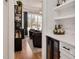 Wet bar transitioning to a living space with natural light at 2412 Toll Mill Ct, Raleigh, NC 27606