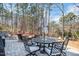 Beautiful patio with outdoor seating and an umbrella-covered table surrounded by a tranquil wooded landscape at 2412 Toll Mill Ct, Raleigh, NC 27606