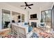 Bright sunroom with a fireplace, white furniture, and a colorful rug at 2412 Toll Mill Ct, Raleigh, NC 27606