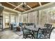 Relaxing screened back porch with comfortable seating, outdoor table, and wooded views at 242 Sweet Pine Cir, Pittsboro, NC 27312