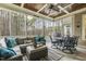 Enjoy outdoor living on this screened-in porch with comfortable seating and wooded backyard views at 242 Sweet Pine Cir, Pittsboro, NC 27312