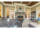 Outdoor fireplace and seating area, which leads out to the backyard through glass paneled doors at 242 Sweet Pine Cir, Pittsboro, NC 27312