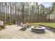 Stone patio with fire pit and seating area, offering a perfect spot for outdoor gatherings at 242 Sweet Pine Cir, Pittsboro, NC 27312