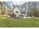 Expansive backyard featuring a fire pit, patio area, and screened porch, perfect for outdoor entertaining at 242 Sweet Pine Cir, Pittsboro, NC 27312
