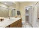Well-lit bathroom features a neutral color palette, tile surround and marble countertops, complemented by a walk-in closet at 242 Sweet Pine Cir, Pittsboro, NC 27312