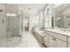 Bright bathroom with dual sinks, walk in shower, and soaking tub with shuttered window at 242 Sweet Pine Cir, Pittsboro, NC 27312