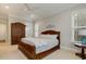 Spacious bedroom with neutral carpet, ceiling fan, and a large wooden wardrobe at 242 Sweet Pine Cir, Pittsboro, NC 27312