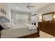 Spacious bedroom with neutral carpet, ceiling fan, and dresser with a decorative mirror at 242 Sweet Pine Cir, Pittsboro, NC 27312