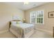 Bedroom with neutral paint, white bedding, and a window at 242 Sweet Pine Cir, Pittsboro, NC 27312