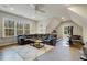 Spacious bonus room with a large sectional sofa, ceiling fan, natural light, and exercise equipment at 242 Sweet Pine Cir, Pittsboro, NC 27312