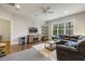 Inviting bonus room featuring a sectional sofa, TV, ceiling fan, natural light, and exercise area at 242 Sweet Pine Cir, Pittsboro, NC 27312
