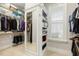 Walk-in closet with ample storage shelves and mirrored door at 242 Sweet Pine Cir, Pittsboro, NC 27312