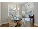 Dining room with vaulted ceilings and a view to built in cabinets and piano at 242 Sweet Pine Cir, Pittsboro, NC 27312