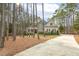 Elegant home with a stone and siding exterior, complemented by mature trees and a long driveway at 242 Sweet Pine Cir, Pittsboro, NC 27312