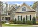 Charming home with a stone facade, well-manicured landscaping, and classic architectural details at 242 Sweet Pine Cir, Pittsboro, NC 27312